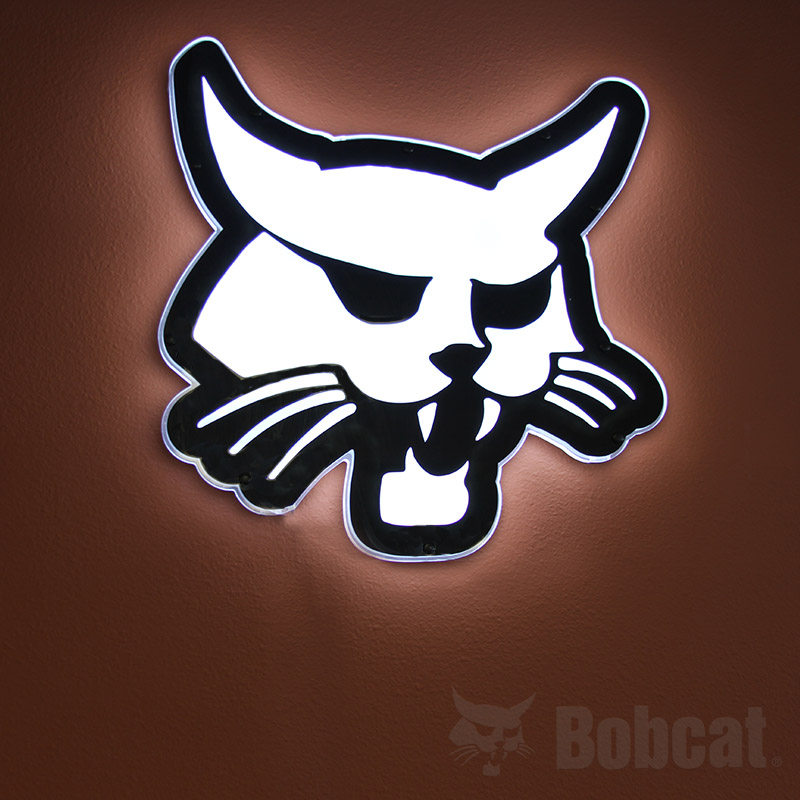 Genuine Bobcat LED lighted sign, 7325606, shown hanging on a wall.